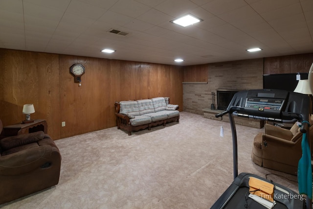 workout area with wood walls, carpet, and visible vents