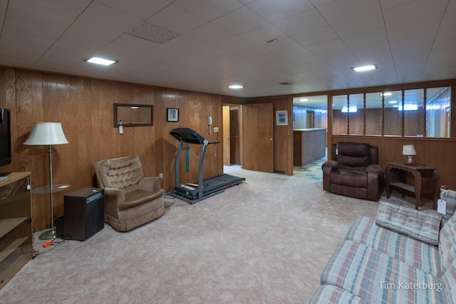 living room with carpet floors and wood walls