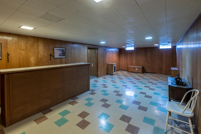 bar featuring wooden walls and light floors