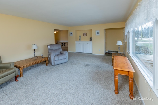 interior space featuring carpet floors, baseboards, visible vents, and a ceiling fan