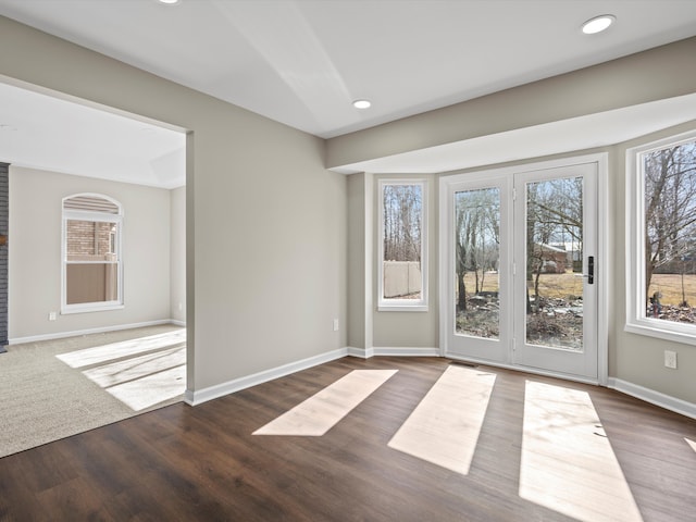 spare room featuring recessed lighting, wood finished floors, and baseboards