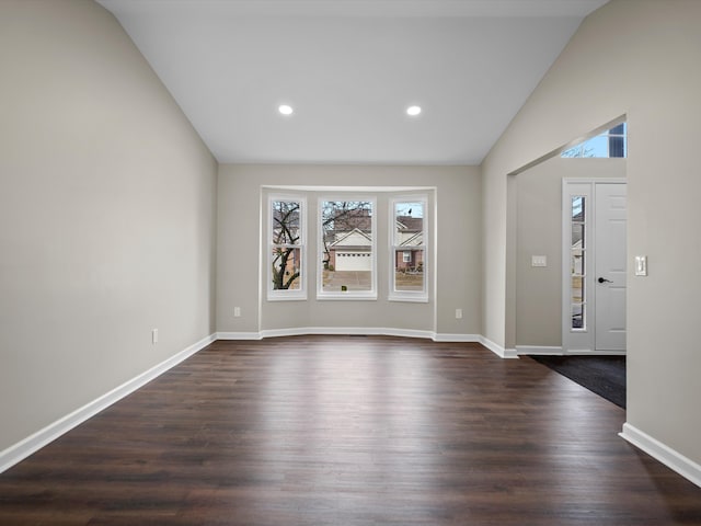 foyer featuring dark wood-type flooring, recessed lighting, vaulted ceiling, and baseboards