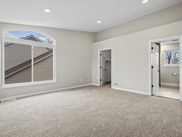 unfurnished bedroom featuring recessed lighting, visible vents, baseboards, and light colored carpet