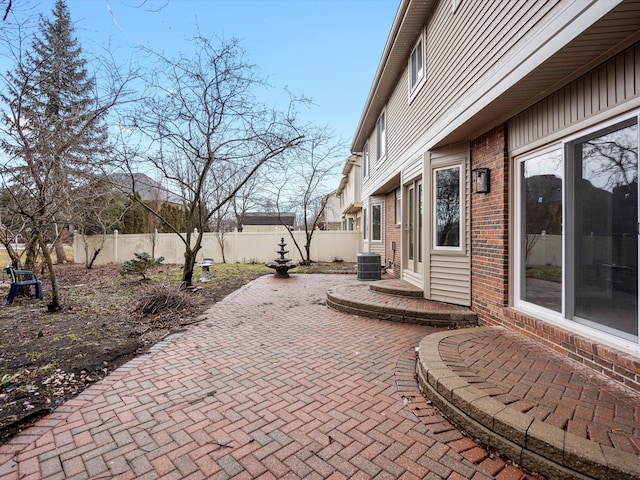 view of patio with entry steps, central air condition unit, and fence private yard