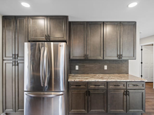 kitchen featuring freestanding refrigerator, dark wood finished floors, and dark brown cabinetry