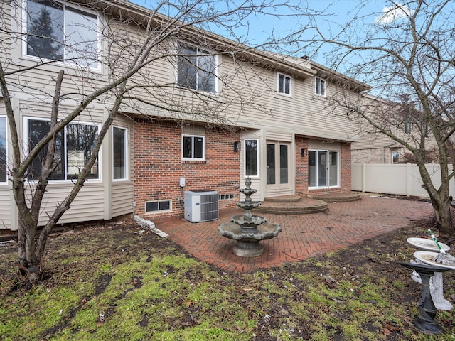 back of property featuring french doors, a patio, fence, and central AC unit