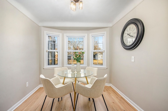 dining room with light wood-style floors and baseboards