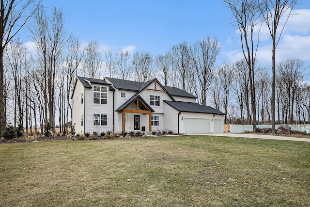 view of front facade with driveway, a front lawn, and an attached garage