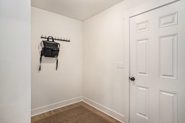 interior space featuring baseboards and wood finished floors