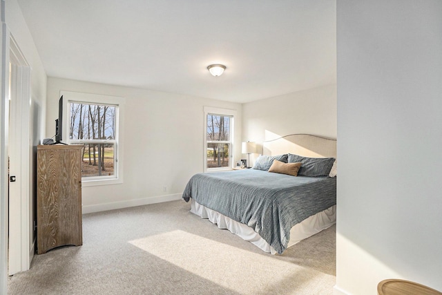 bedroom featuring carpet and baseboards