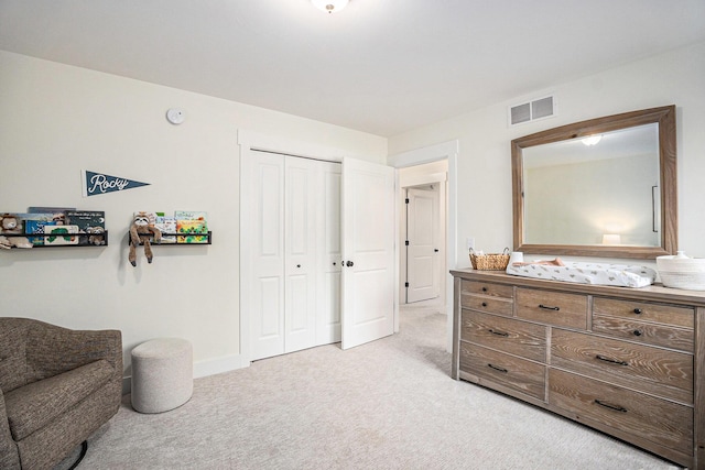 interior space featuring baseboards, visible vents, and light colored carpet