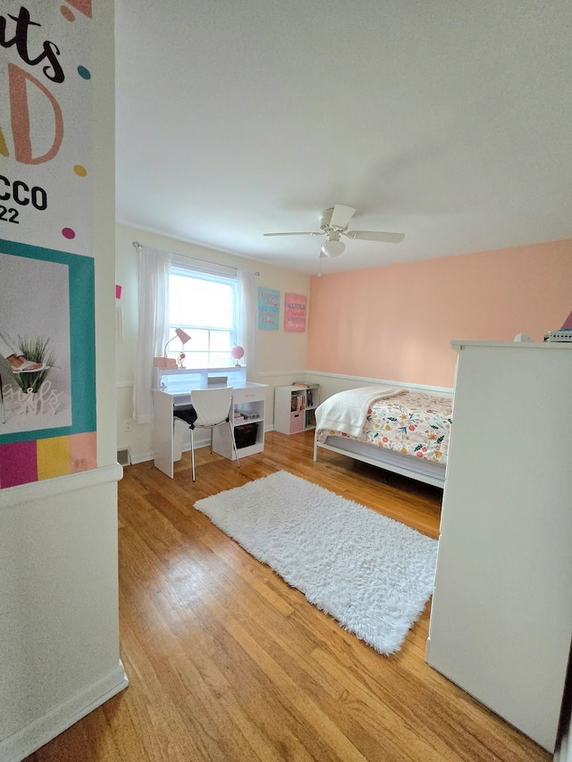 bedroom with ceiling fan and wood finished floors