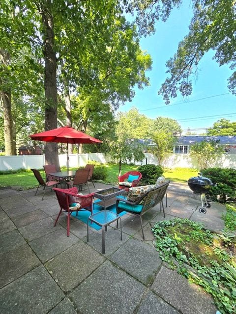 view of patio featuring outdoor dining space and fence