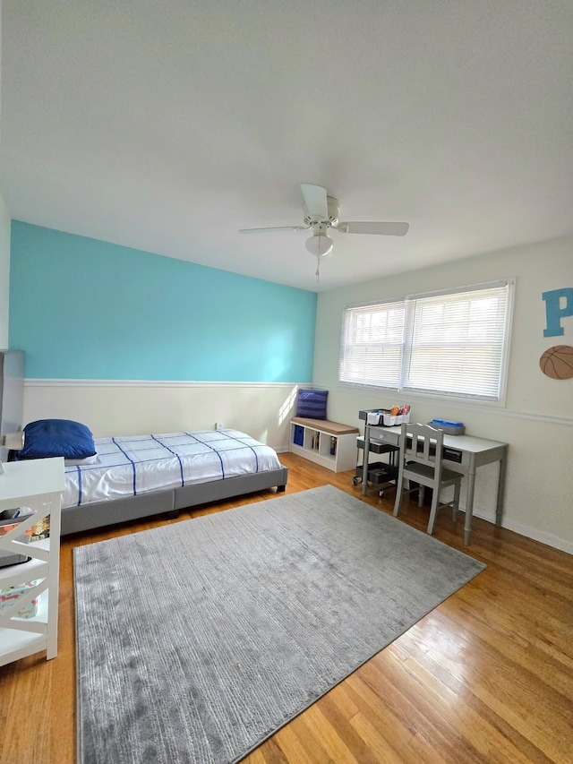 living room with ceiling fan and wood finished floors