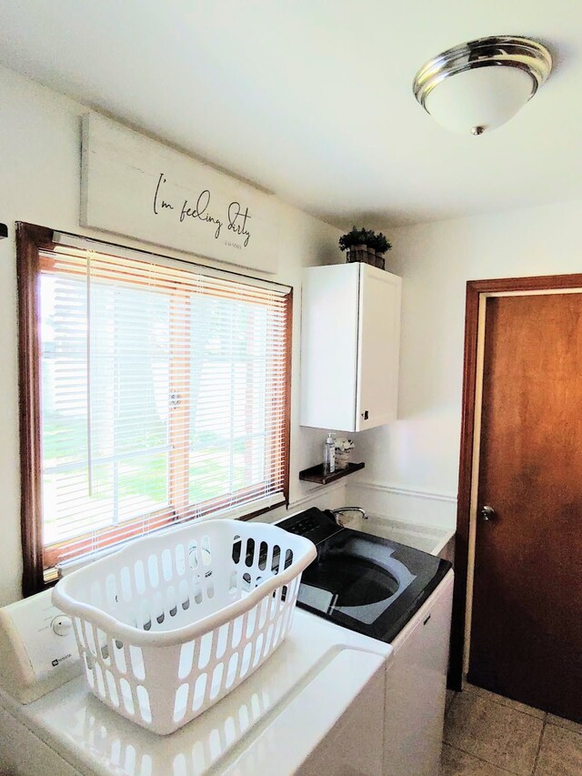 kitchen with white cabinetry and separate washer and dryer