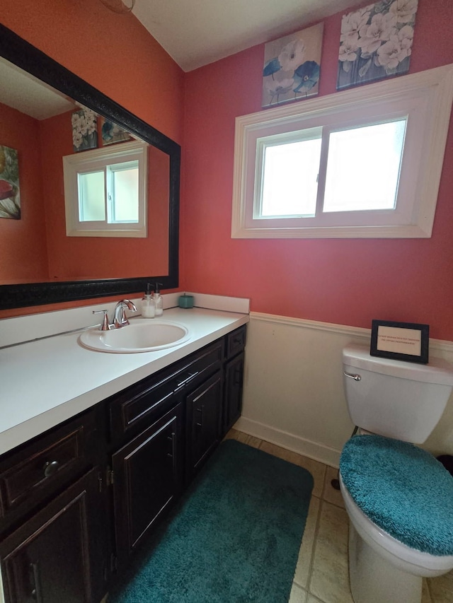 bathroom featuring tile patterned flooring, vanity, and toilet