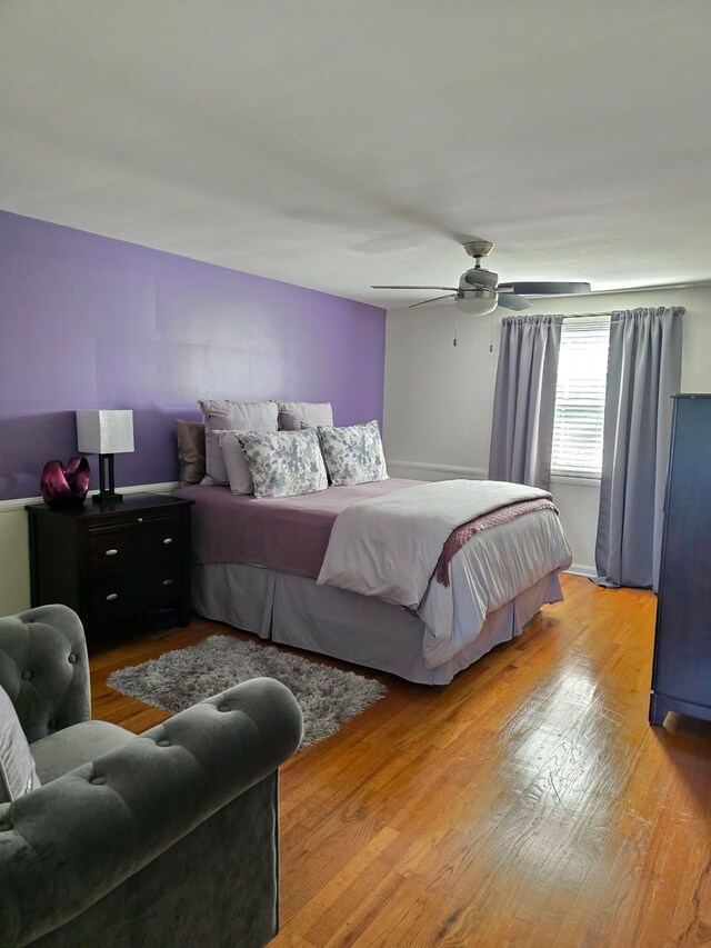 bedroom featuring a ceiling fan and wood finished floors