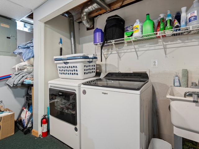 washroom with laundry area, electric panel, a sink, and separate washer and dryer