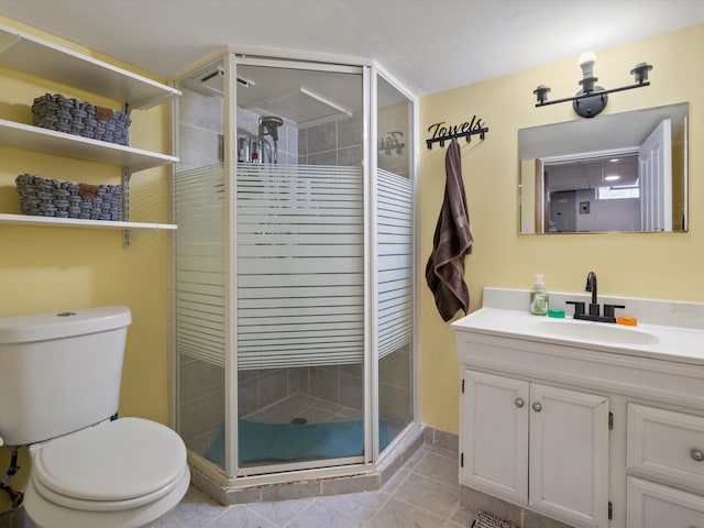 bathroom featuring toilet, a shower stall, tile patterned flooring, and vanity