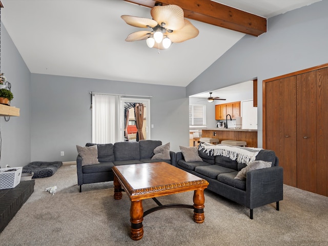 living area featuring lofted ceiling with beams, a ceiling fan, and light colored carpet