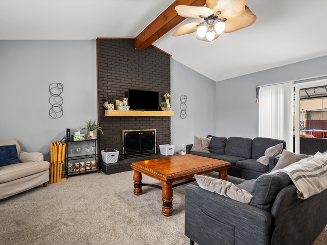 living area featuring vaulted ceiling with beams, a brick fireplace, ceiling fan, and carpet floors