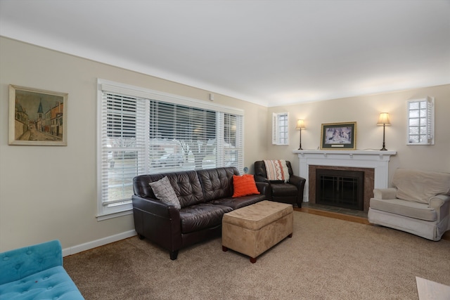 carpeted living area featuring a fireplace with flush hearth and baseboards