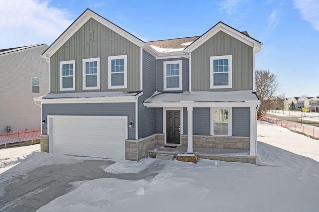 view of front of property with a garage, board and batten siding, and fence