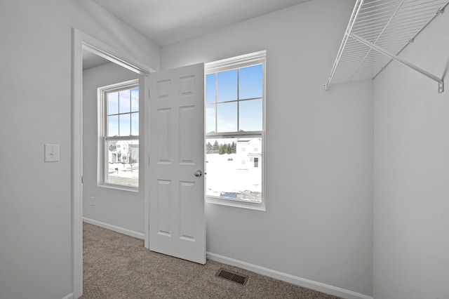 interior space with visible vents and carpet flooring