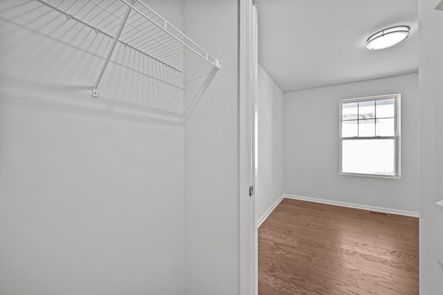 walk in closet featuring visible vents and wood finished floors