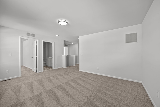 unfurnished bedroom featuring carpet floors, baseboards, and visible vents