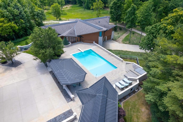 view of pool featuring a diving board, a fenced in pool, and a patio