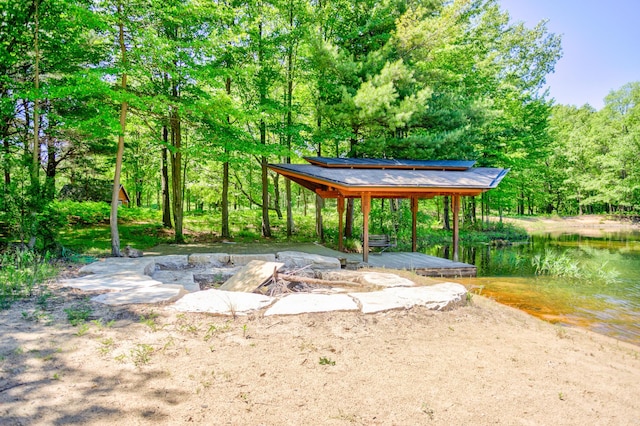 exterior space featuring a water view and a wooded view