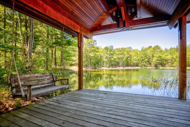 dock area with a water view and a wooded view