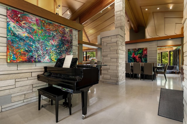 interior space featuring high vaulted ceiling, beamed ceiling, and decorative columns