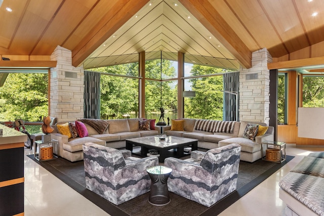 sunroom / solarium with vaulted ceiling, wooden ceiling, and decorative columns