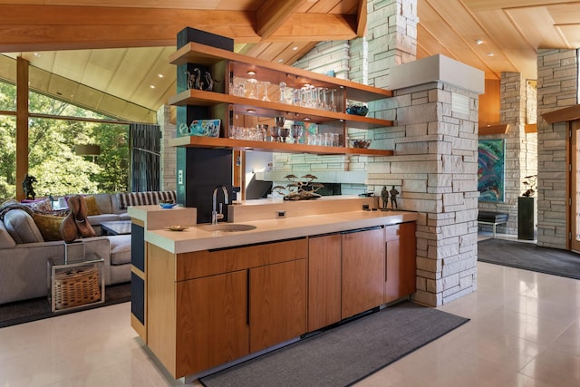 interior space with light tile patterned floors, high vaulted ceiling, a sink, and beam ceiling