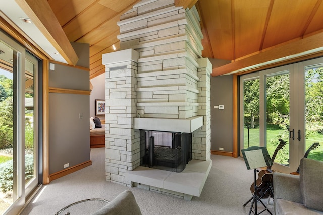 carpeted living room featuring a healthy amount of sunlight, a fireplace, and lofted ceiling