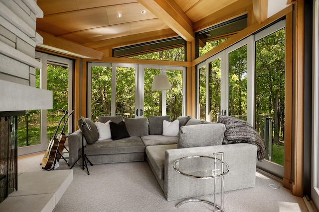 sunroom featuring beamed ceiling, plenty of natural light, and wooden ceiling