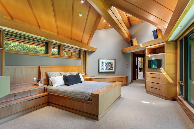 carpeted bedroom with lofted ceiling with beams and wooden ceiling