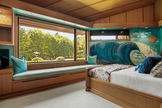 bedroom with light colored carpet and vaulted ceiling