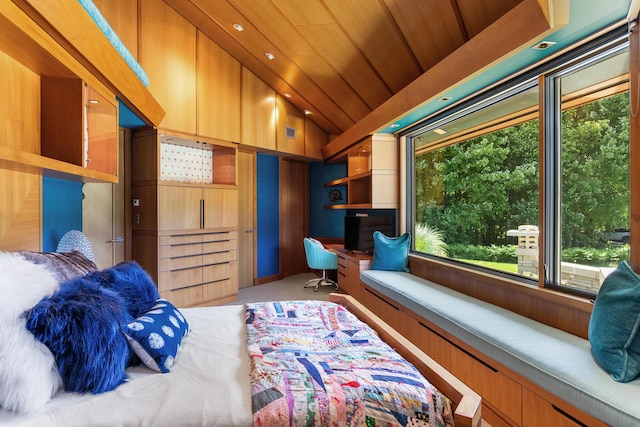 bedroom with lofted ceiling, wood ceiling, and built in study area