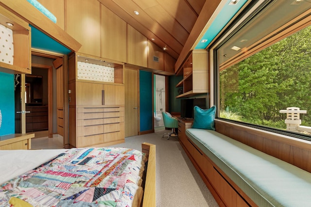 bedroom with vaulted ceiling, visible vents, and light colored carpet