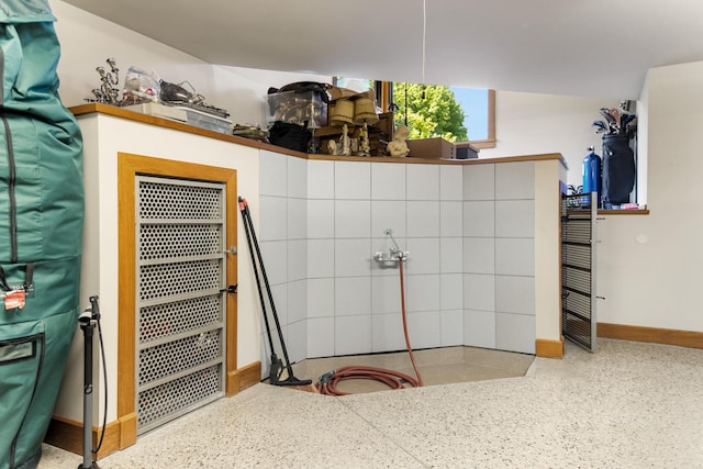 bathroom with baseboards and speckled floor