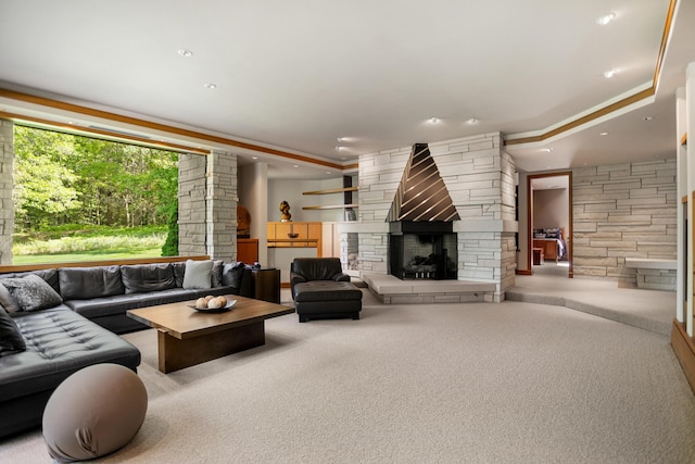 living area with a stone fireplace, carpet flooring, and recessed lighting