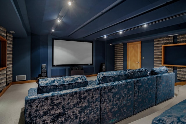 carpeted cinema with wallpapered walls, baseboards, visible vents, and track lighting