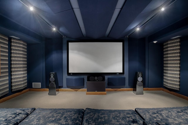 carpeted cinema featuring visible vents and baseboards