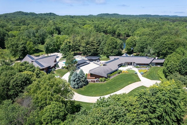 birds eye view of property featuring a view of trees