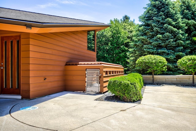 view of property exterior with a patio area