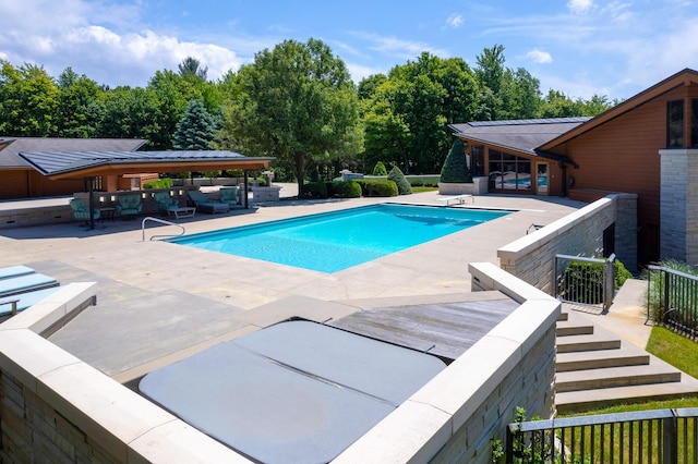 pool featuring an outdoor hangout area, a patio, and fence