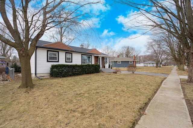 view of front of property featuring a chimney and a front yard